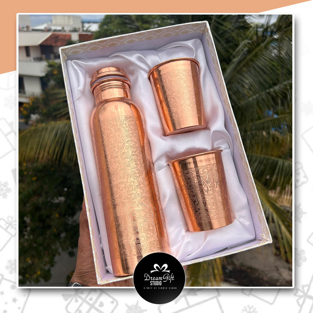 a good looking designer box with a textured copper bottle and two copper glass