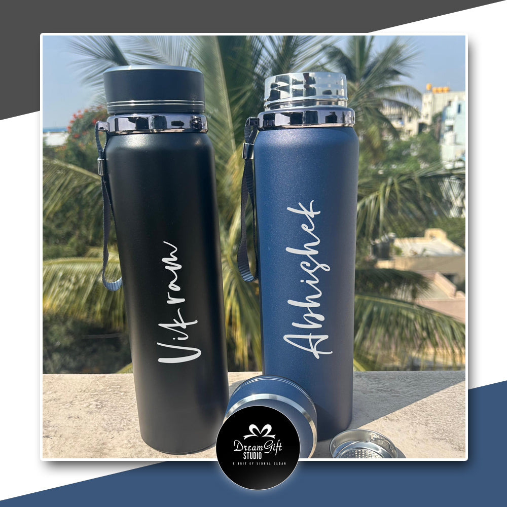 Both customised black and blue bottles name printed placed on a shelf in a close up view with cap open reflecting the inner steel and good quality
